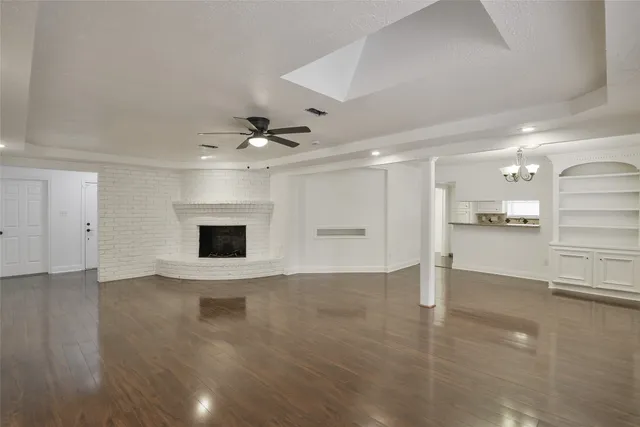 a view of an empty room with a kitchen