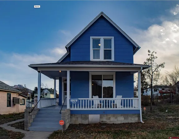 a view of a house with wooden deck front of house