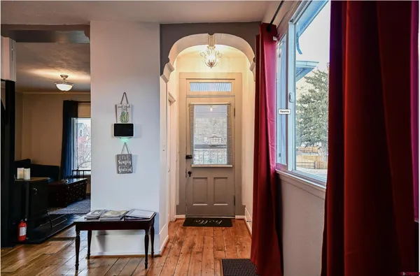a view of a hallway view with wooden floor and a dining room view