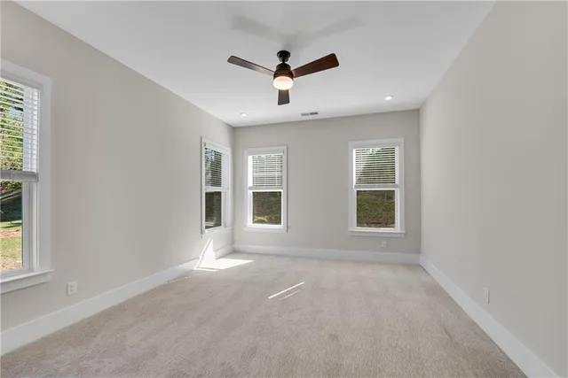 a bedroom with a bed a mirror and a large window