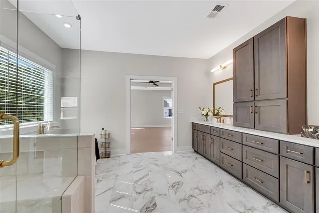 a bathroom with a toilet a sink a mirror a bathtub and window