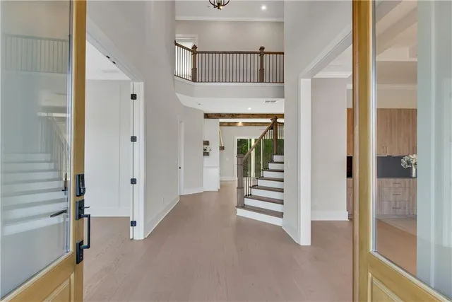 a view of entryway and hall with wooden floor