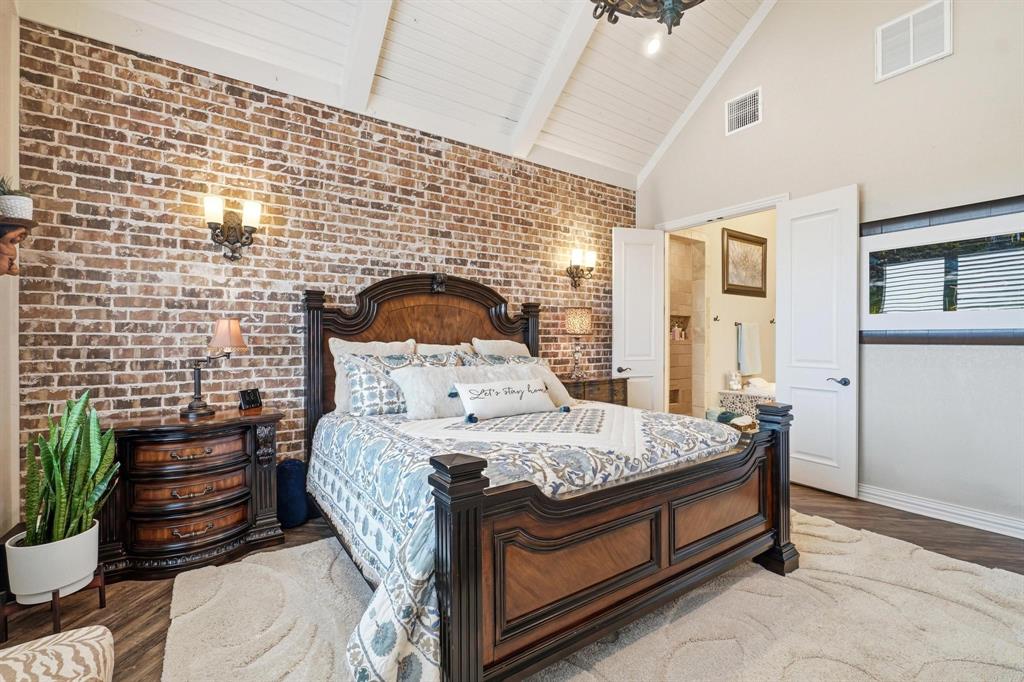 249 Rising Star Drive Abilene, TX 79606 - Photo 15 of 40 a bed sitting in a bedroom next to a lamp with a balcony