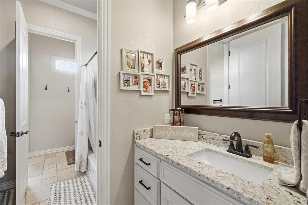 249 Rising Star Drive Abilene, TX 79606 - Photo 21 of 40 a bathroom with a granite countertop sink and a mirror