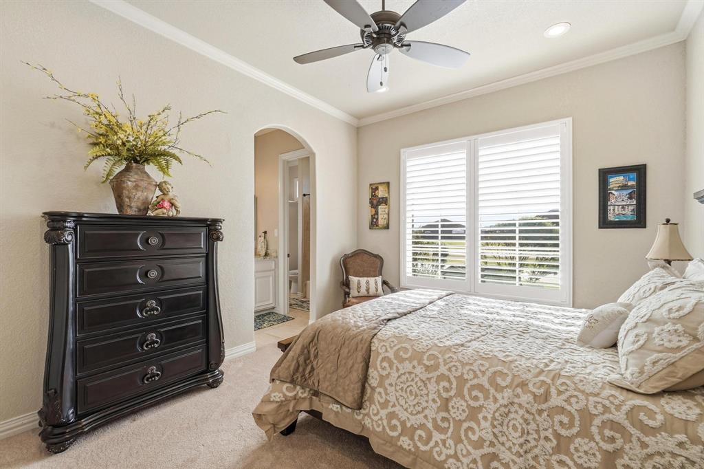 249 Rising Star Drive Abilene, TX 79606 - Photo 24 of 40 a spacious bedroom with a bed and a chandelier