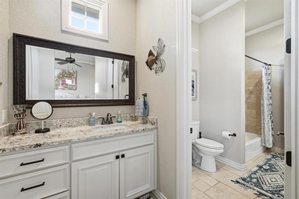 249 Rising Star Drive Abilene, TX 79606 - Photo 27 of 40 a bathroom with a granite countertop sink toilet and mirror