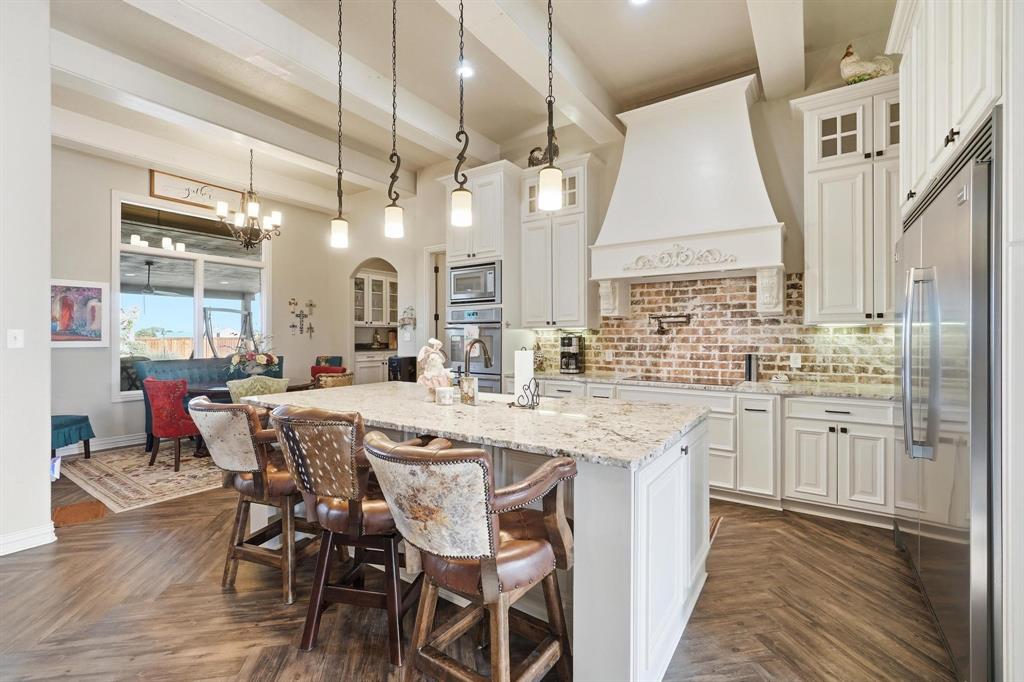 249 Rising Star Drive Abilene, TX 79606 - Photo 8 of 40 a kitchen with center island table and chairs