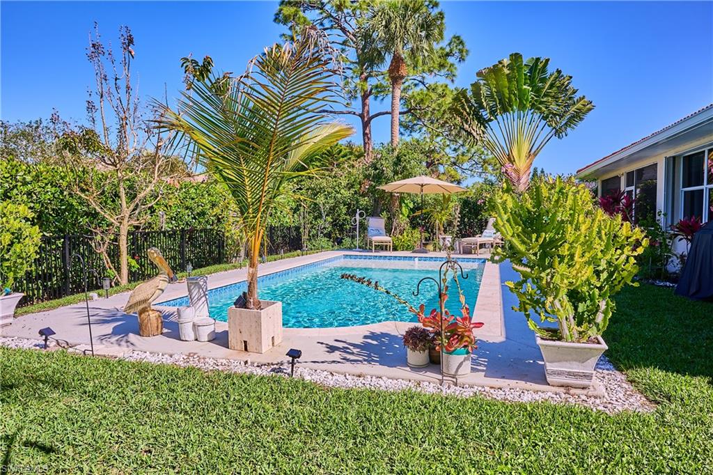 186 Muirfield Circle Naples, FL 34113 - Photo 3 of 36 a view of a house with a yard and potted plants