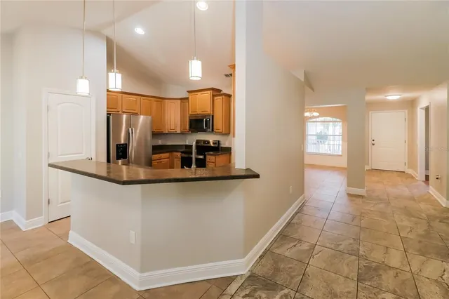 a view of a kitchen with a sink and a refrigerator