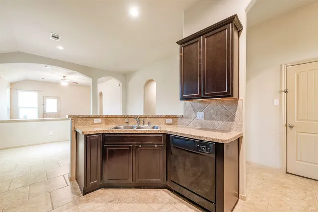 a kitchen with a sink stove and cabinets