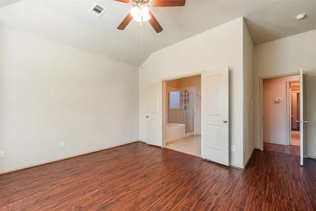 a view of empty room with wooden floor