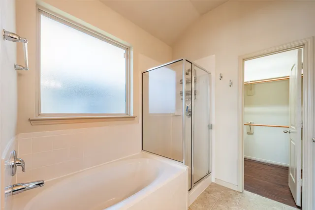 a bathroom with a bathtub and a shower
