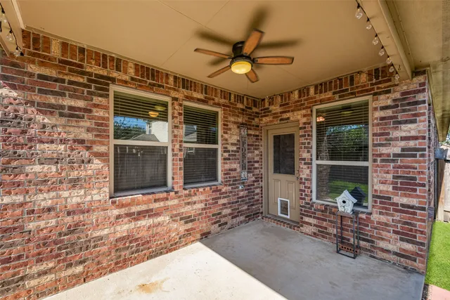 a view of a porch with a table and chairs