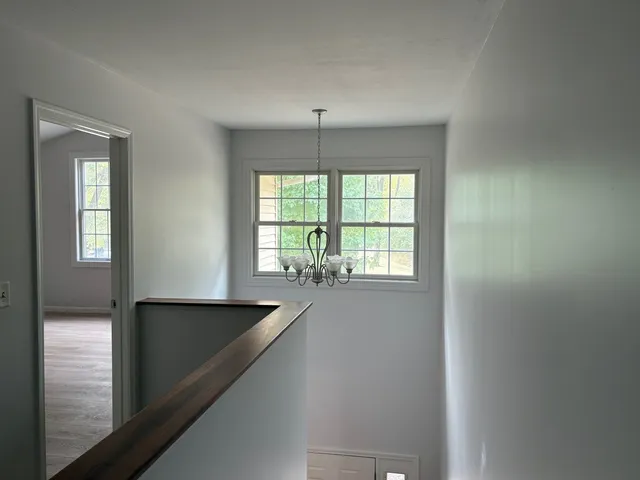 a view of a hallway with an entryway