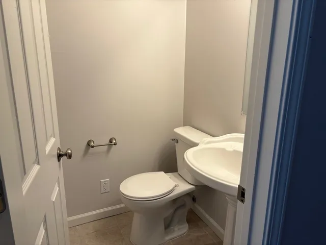 a white toilet sitting next to a shower