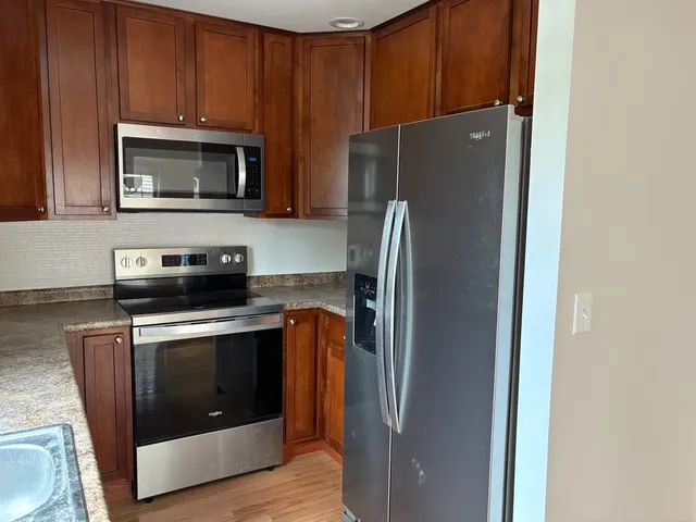 a kitchen with a stove microwave and refrigerator
