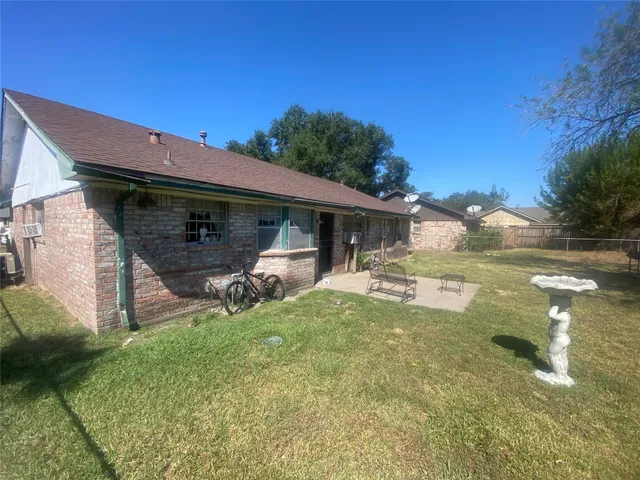 a view of a house with backyard porch and sitting area