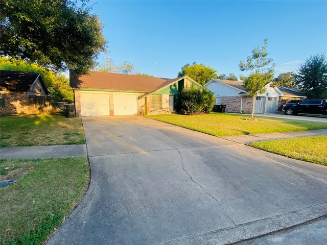 a view of a house with pool and a yard