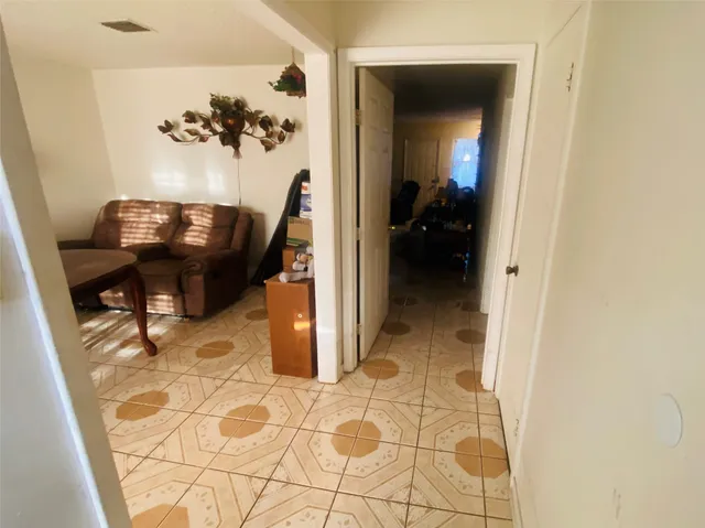 a view of a hallway to a livingroom and a hallway