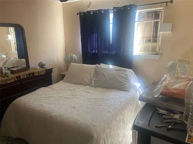 a bedroom with a bed and a mirror