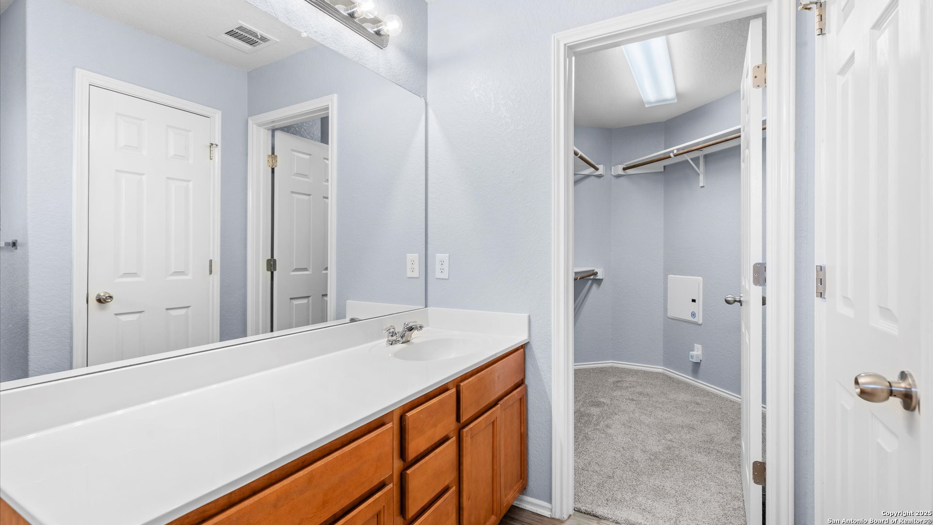 2744 Sterling Way Schertz, TX 78108 - Photo 16 of 22 a bathroom with a tub sink vanity and mirror