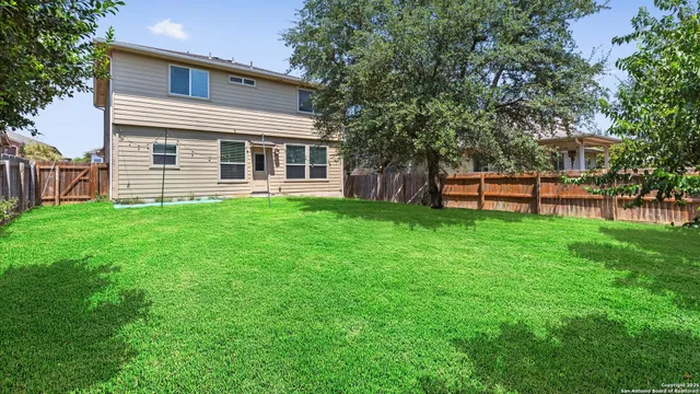 a view of a house with a yard and sitting area