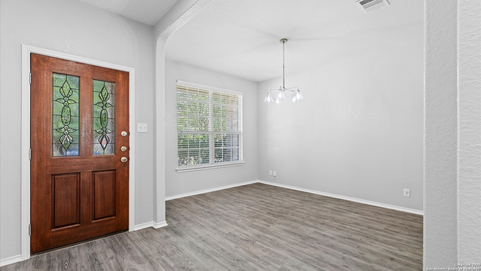 2744 Sterling Way Schertz, TX 78108 - Photo 3 of 22 a view of an empty room with wooden floor and a window