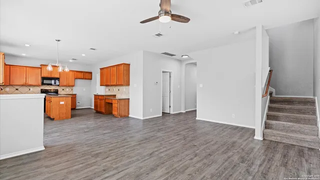a view of a kitchen with furniture and wooden floor