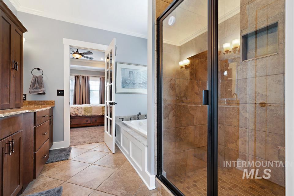 8271 Washoe Road Fruitland, ID 83619 - Photo 22 of 29 Walk-in shower with clear glass enclosure and tiled walls