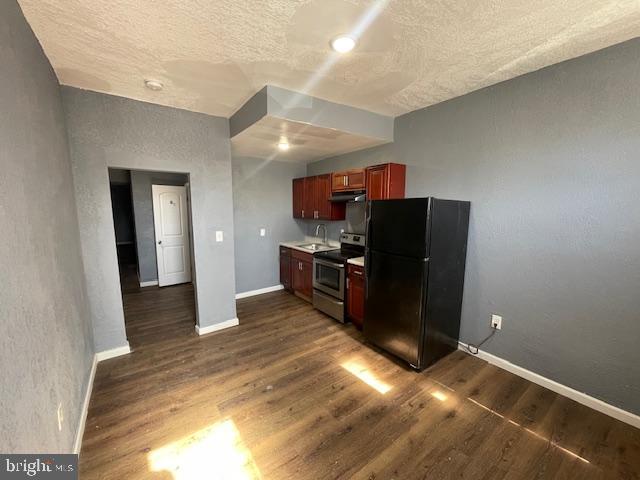 1066 West Fayette Street, Unit 1 Baltimore, MD 21223 - Photo 2 of 4 a kitchen with a refrigerator and a sink