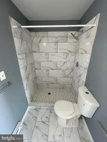 a bathroom with a toilet and a shower