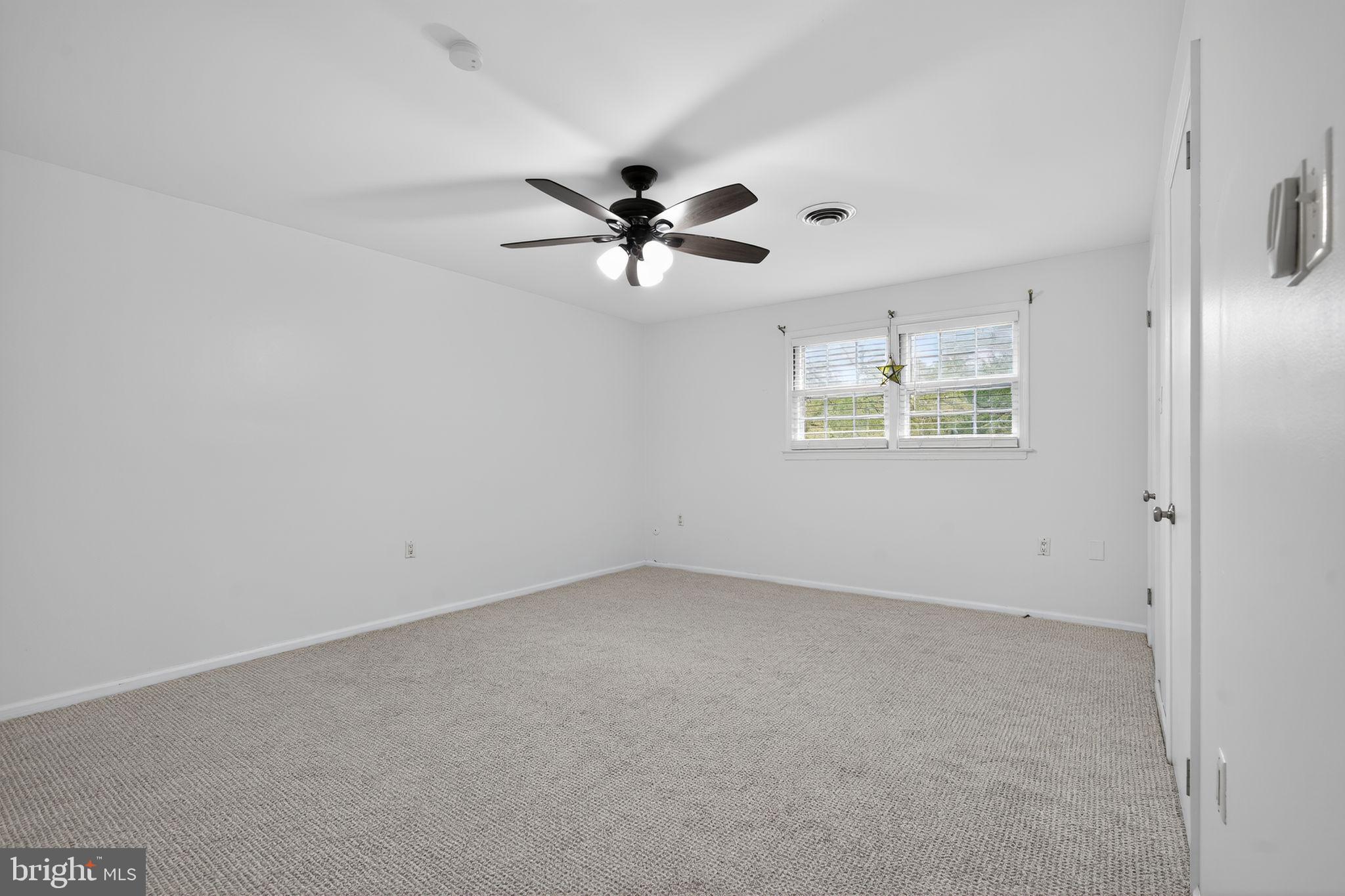 908 Yardley Commons Yardley, PA 19067 - Photo 10 of 28 an empty room with windows and ceiling fan