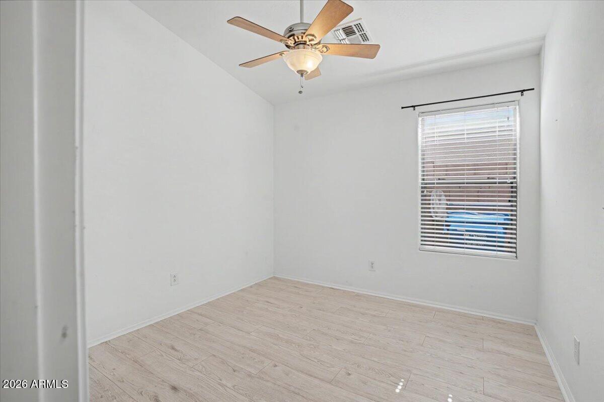 24726 North 29th Place Phoenix, AZ 85024 - Photo 12 of 31 an empty room with a window and a ceiling fan