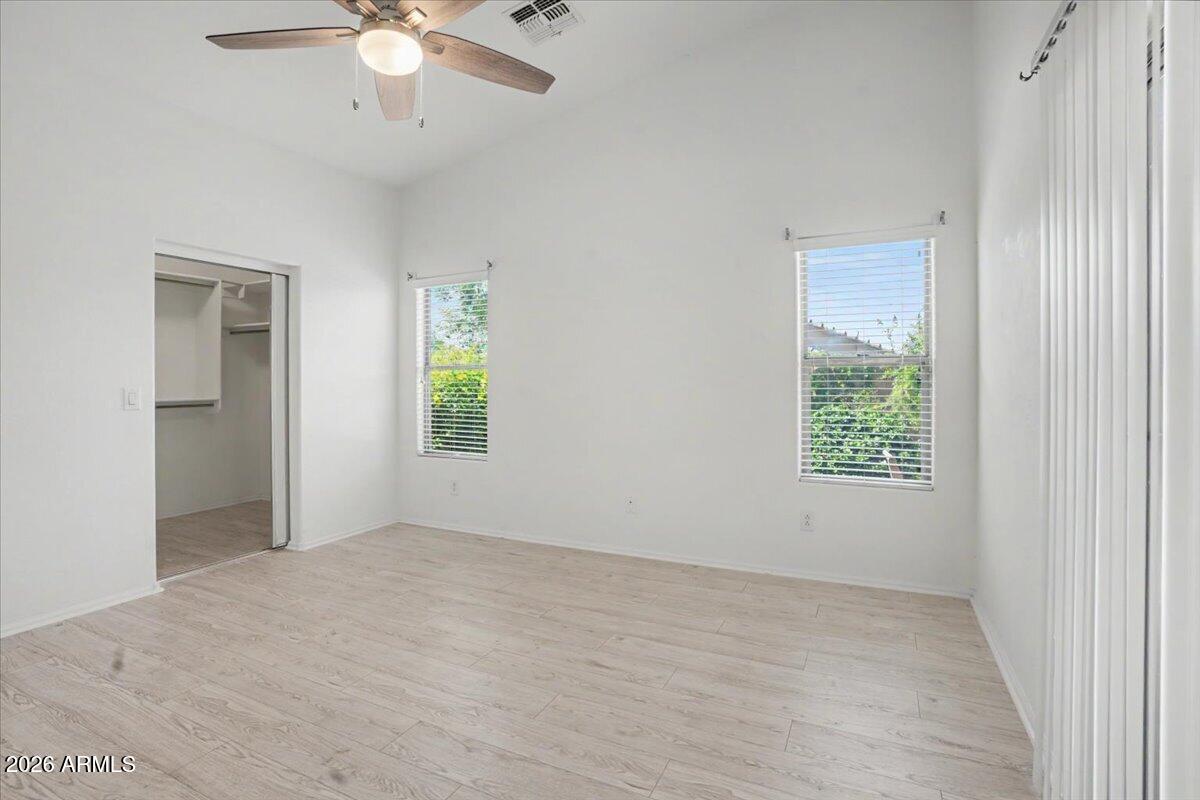 24726 North 29th Place Phoenix, AZ 85024 - Photo 16 of 31 an empty room with windows and fan