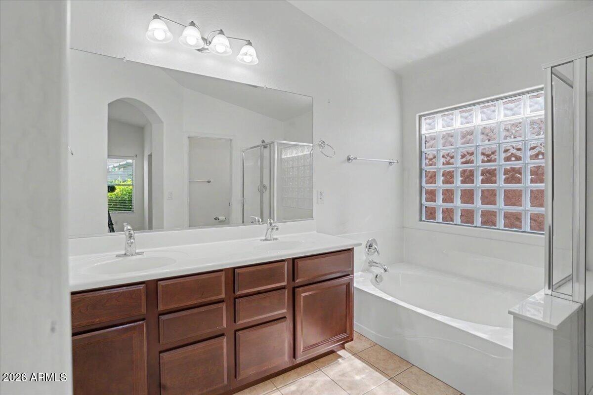 24726 North 29th Place Phoenix, AZ 85024 - Photo 18 of 31 a bathroom with a tub a sink double vanity and a mirror