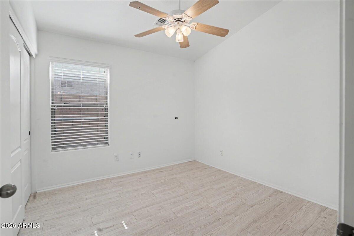24726 North 29th Place Phoenix, AZ 85024 - Photo 21 of 31 an empty room with a window and a fan