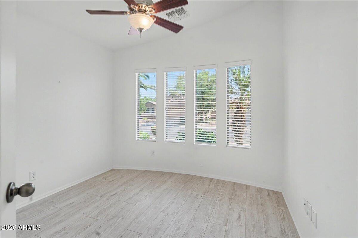 24726 North 29th Place Phoenix, AZ 85024 - Photo 10 of 31 an empty room with a window and a ceiling fan