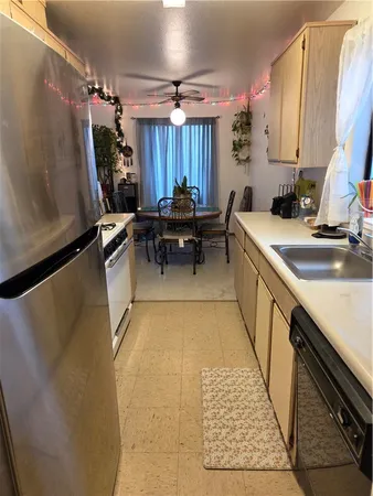 a kitchen with a sink and a refrigerator