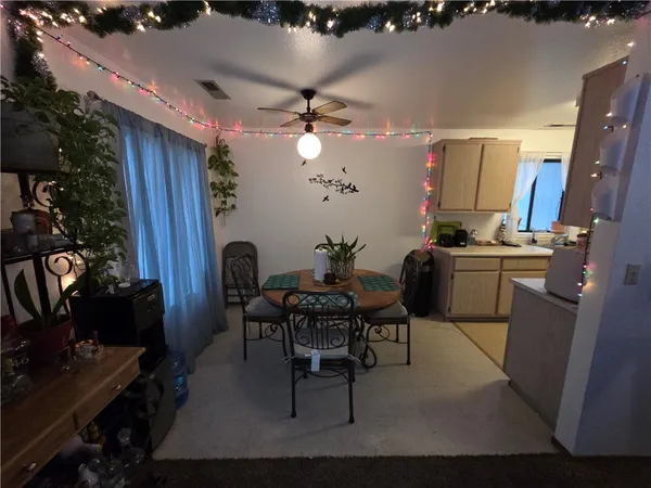 a dining room with furniture and chandelier