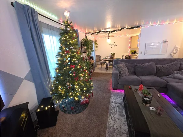 a living room with furniture and flowers