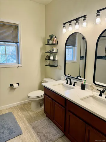a bathroom with 2 sink and a mirror
