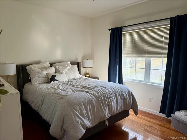 a large bed sitting in a bedroom next to a window