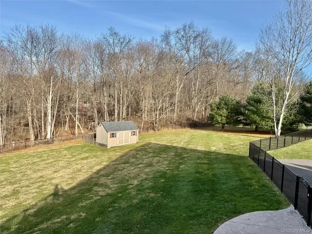 a white house with a yard and sitting area