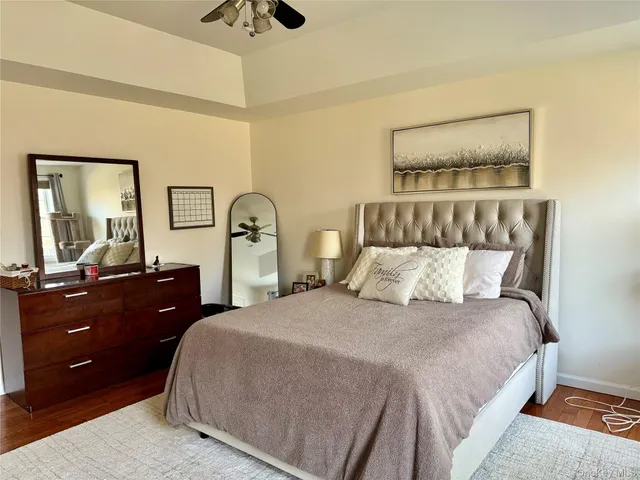 a bedroom with a large bed and a chandelier