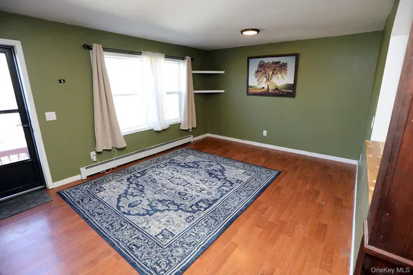 a kitchen with stainless steel appliances granite countertop a stove a refrigerator a sink dishwasher a dining table and chairs with wooden floor