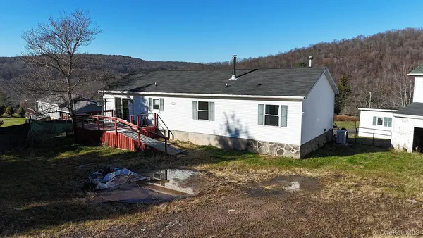a view of a house with backyard and sitting area