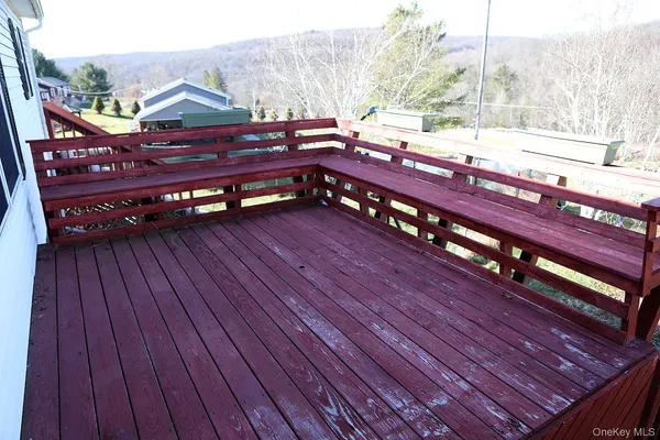 a view of a roof deck with wooden floor and barbeque oven