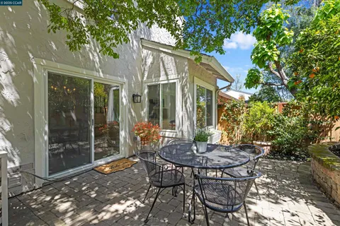 a view of a patio with table and chairs and potted plants
