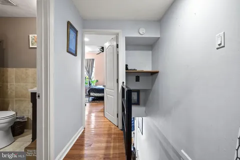a view of a hallway with toilet and a hallway