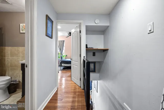 a view of a hallway with toilet and a hallway